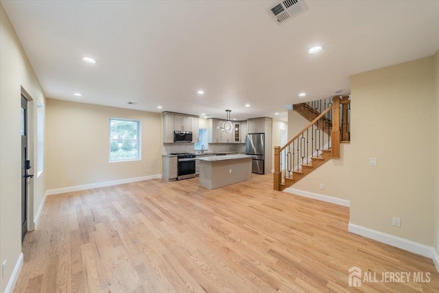 17 Fourth St, Hillsborough, NJ 08821 - kitchen with stainless steel appliances, a center island, light wood-type flooring, hanging light fixtures, and recessed lighting