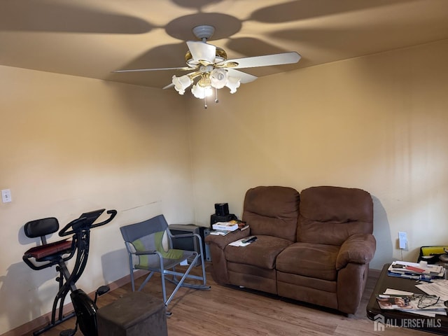 living room with a ceiling fan and wood finished floors