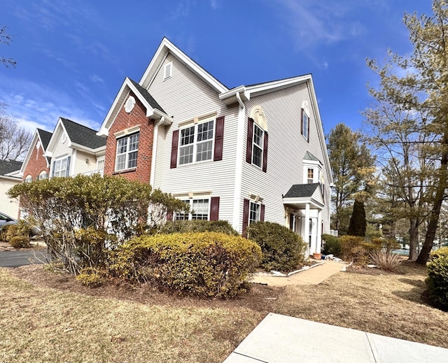 view of side of property with brick siding