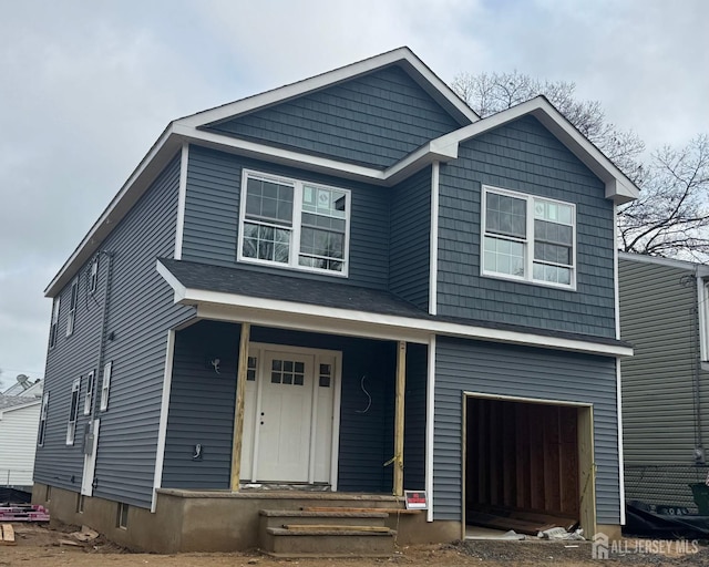 view of front facade featuring a garage and covered porch