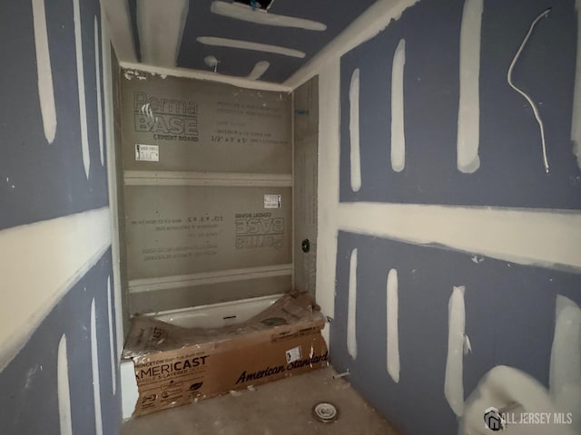 bathroom with unfinished concrete flooring