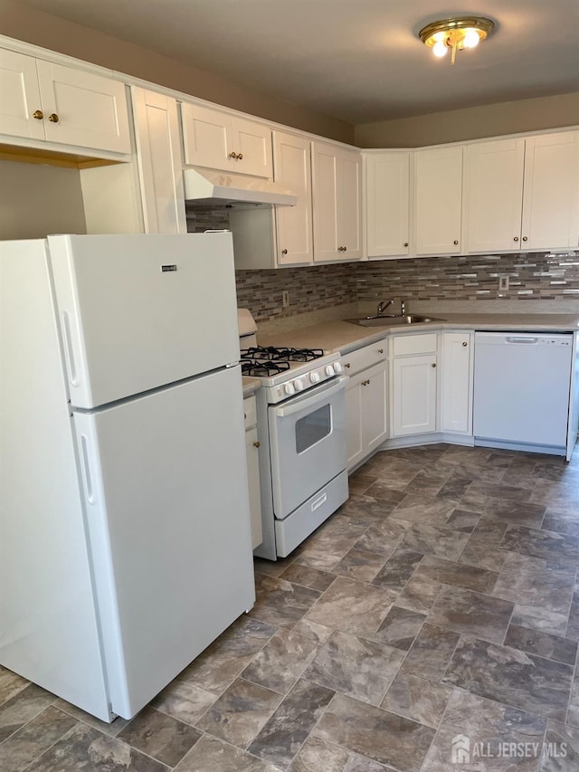 kitchen with under cabinet range hood, a sink, backsplash, white appliances, and white cabinets