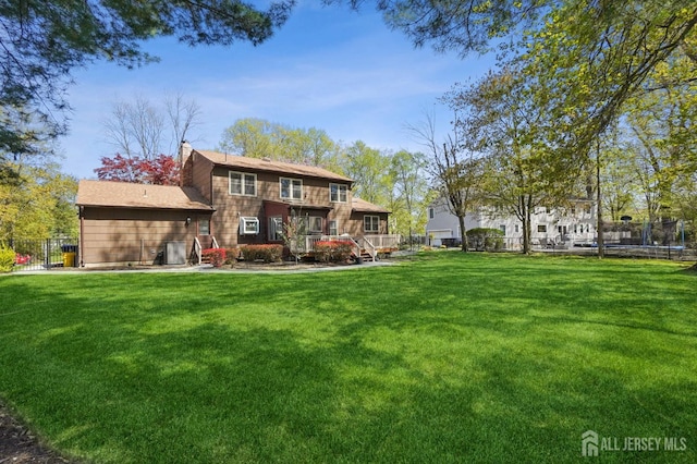4 Franklin Ct, East Brunswick, NJ 08816 - rear view of house featuring a trampoline, a chimney, and a wooden deck