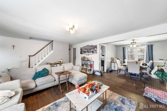 living room with stairs, a ceiling fan, and wood finished floors