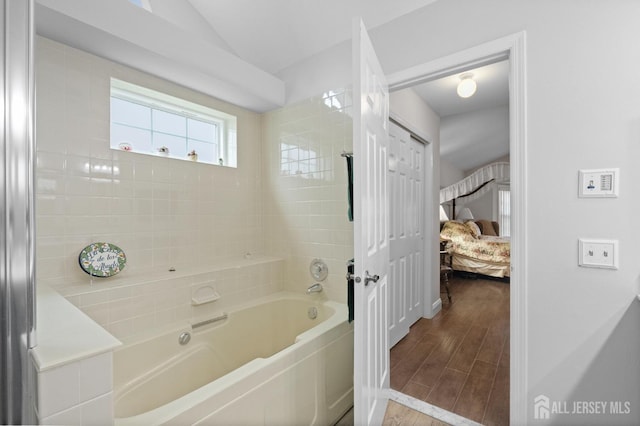 31 Ingram Dr, Monroe, NJ 08831 - bathroom with ensuite bathroom, wood finished floors, vaulted ceiling, and tub / shower combination
