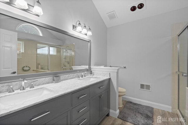31 Ingram Dr, Monroe, NJ 08831 - bathroom featuring lofted ceiling, wood finished floors, double vanity, and a shower stall