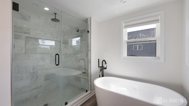 full bath with recessed lighting, a stall shower, and a freestanding tub