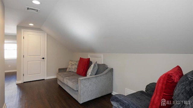 sitting room featuring lofted ceiling, wood finished floors, visible vents, and baseboards