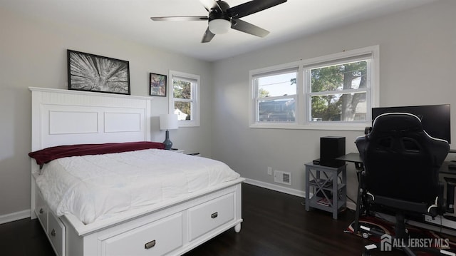 bedroom with ceiling fan, visible vents, baseboards, and dark wood-style floors