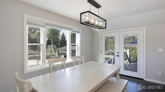 dining room with dark wood finished floors, french doors, baseboards, and a chandelier