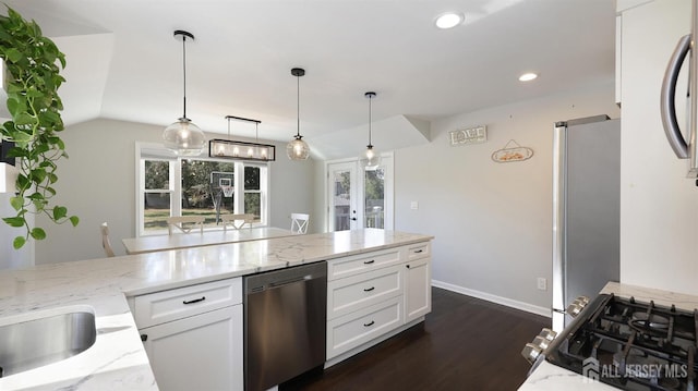 kitchen featuring dark wood-style floors, light stone countertops, appliances with stainless steel finishes, and white cabinets