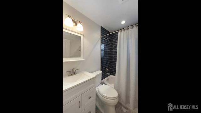 full bath featuring vanity, toilet, and shower / bath combo with shower curtain