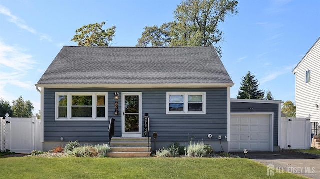 view of front of home with a garage and a front lawn