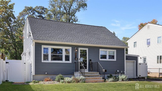 view of front of property with a garage and a front lawn