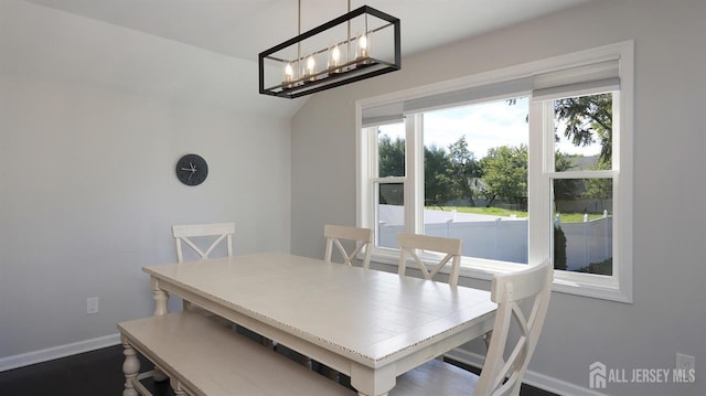 dining area with baseboards and a chandelier