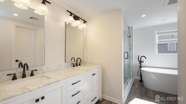 bathroom with a shower stall, visible vents, and a sink