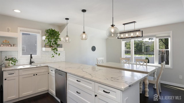 kitchen featuring white cabinetry, open shelves, a peninsula, a sink, and stainless steel dishwasher