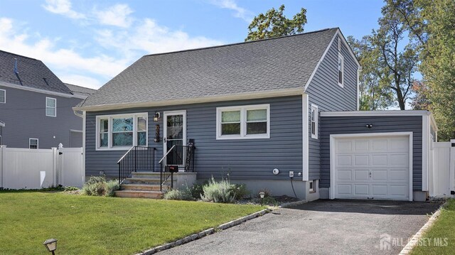 view of front of home featuring a garage and a front yard