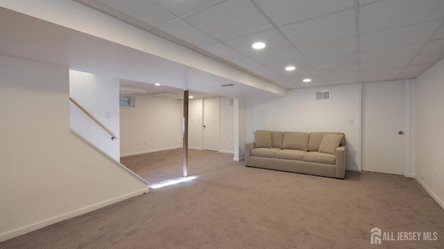 unfurnished living room featuring visible vents, baseboards, recessed lighting, a paneled ceiling, and carpet flooring