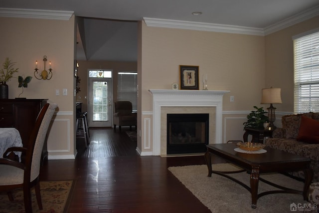 living room featuring dark hardwood / wood-style flooring and crown molding