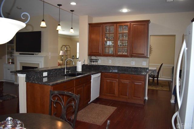 kitchen featuring dark wood-type flooring, kitchen peninsula, white dishwasher, and refrigerator