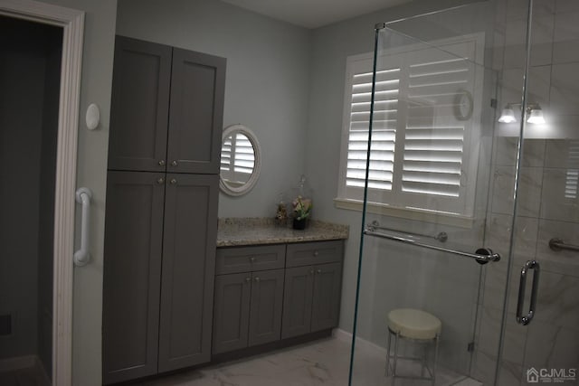 bathroom featuring vanity, tile patterned floors, and walk in shower