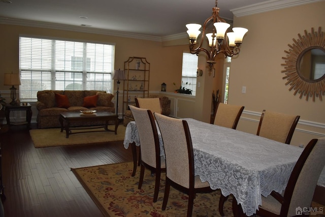 dining area featuring an inviting chandelier, dark hardwood / wood-style floors, and ornamental molding