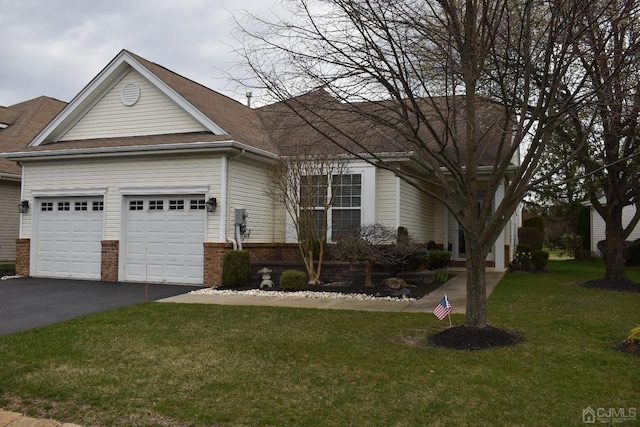 view of front of property with a garage and a front yard