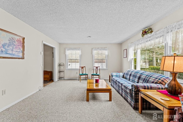 carpeted living area with visible vents, baseboards, and a textured ceiling