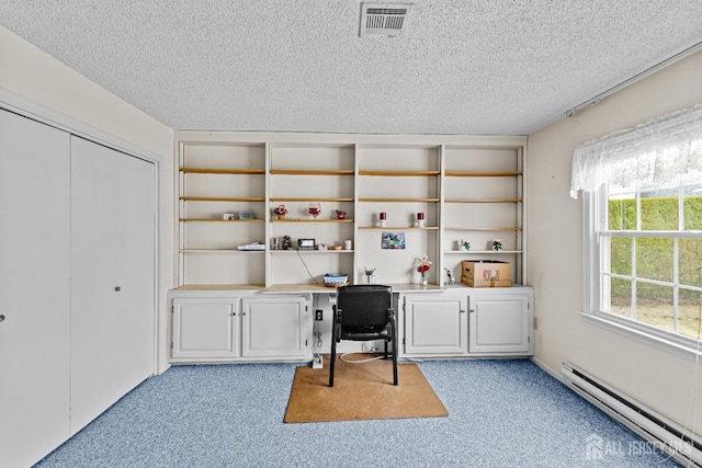 home office featuring a textured ceiling, light colored carpet, visible vents, and a baseboard radiator