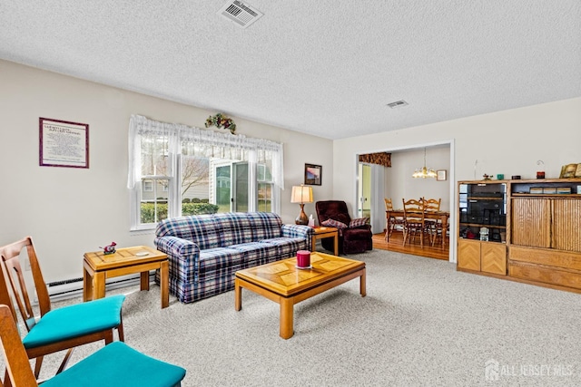 carpeted living area with visible vents, a textured ceiling, an inviting chandelier, and a baseboard radiator