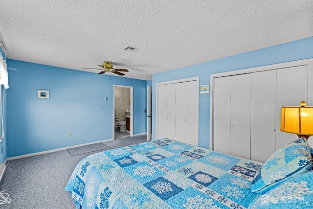 carpeted bedroom with a ceiling fan, visible vents, baseboards, multiple closets, and a textured ceiling