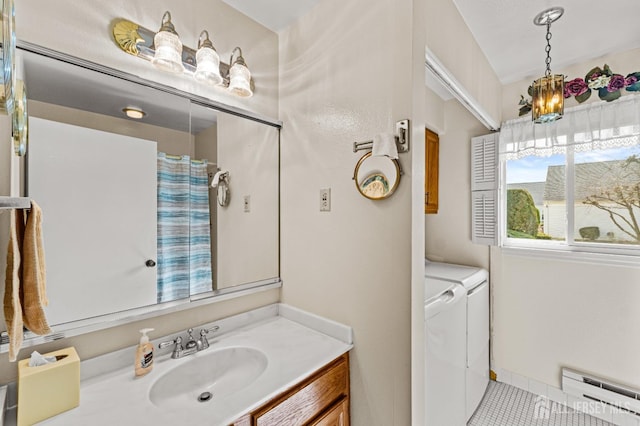 full bath with washer and dryer, a baseboard radiator, a shower with shower curtain, and vanity