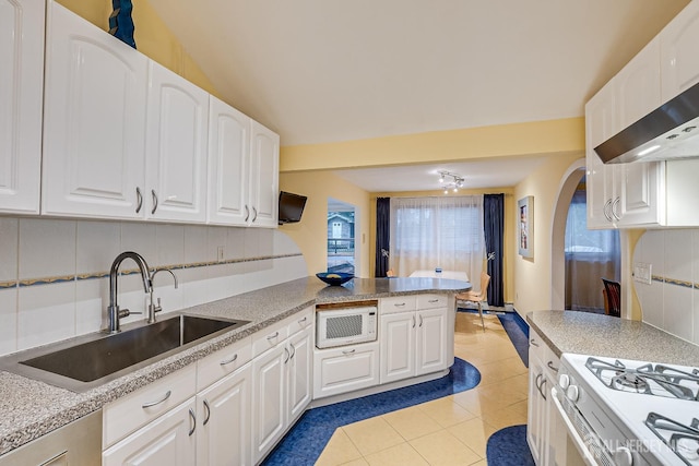 kitchen featuring light tile patterned floors, white appliances, white cabinetry, and sink