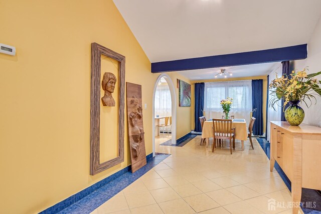 dining area with vaulted ceiling, ceiling fan, and light tile patterned flooring