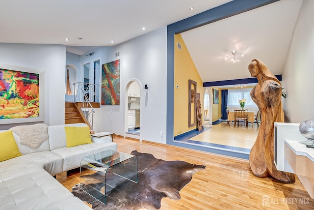 living room with wood-type flooring and lofted ceiling