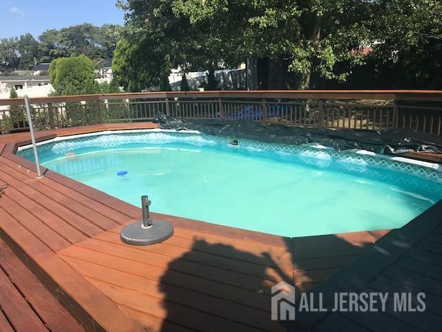 view of swimming pool with a deck and a jacuzzi