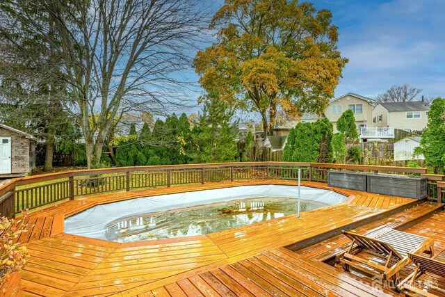 wooden deck with a jacuzzi