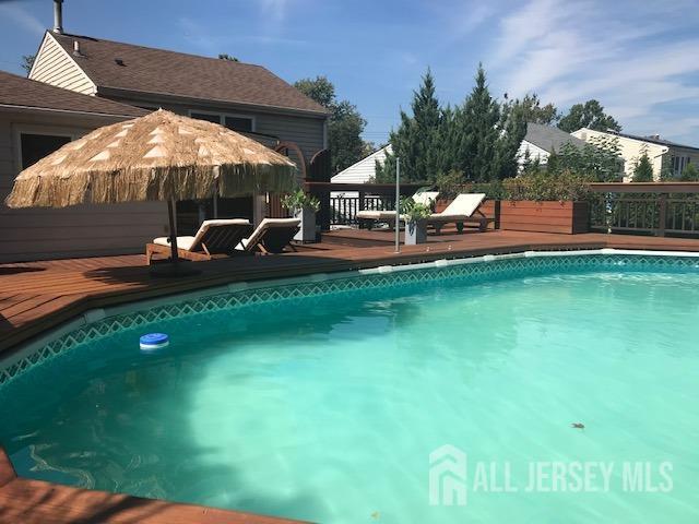 view of swimming pool with a wooden deck