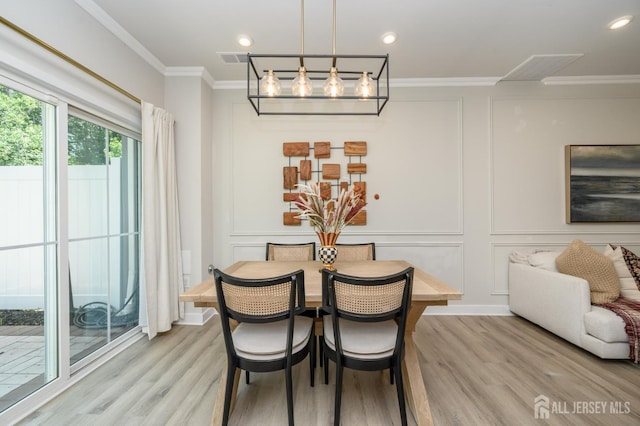 45 Athens Way, Aberdeen, NJ 07721 - dining area featuring light wood-type flooring, crown molding, a decorative wall, and recessed lighting