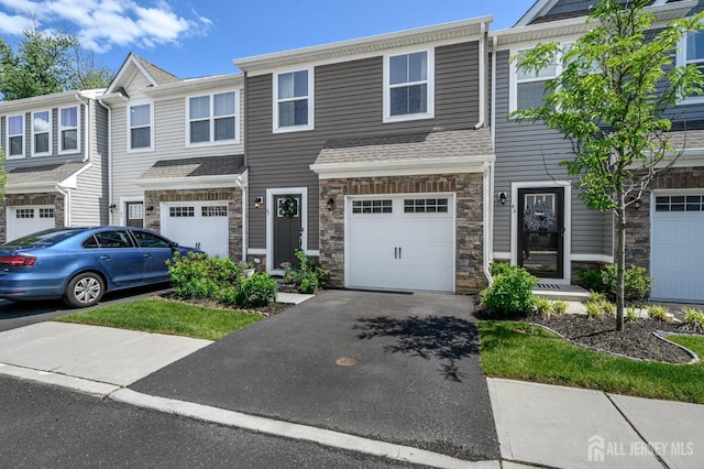 45 Athens Way, Aberdeen, NJ 07721 - townhome / multi-family property featuring stone siding, driveway, and an attached garage