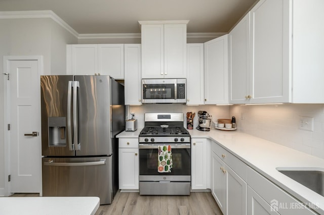45 Athens Way, Aberdeen, NJ 07721 - kitchen featuring stainless steel appliances, light countertops, white cabinets, tasteful backsplash, and light wood-type flooring