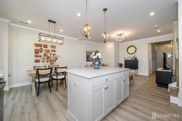 45 Athens Way, Aberdeen, NJ 07721 - kitchen with crown molding, recessed lighting, a kitchen island, light wood-style flooring, and a chandelier