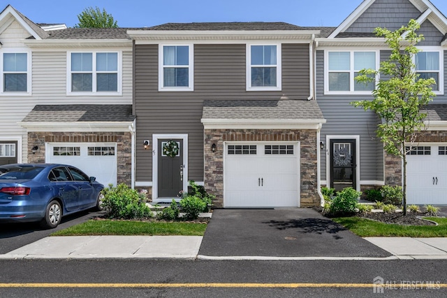 45 Athens Way, Aberdeen, NJ 07721 - townhome / multi-family property featuring an attached garage, asphalt driveway, stone siding, and a shingled roof