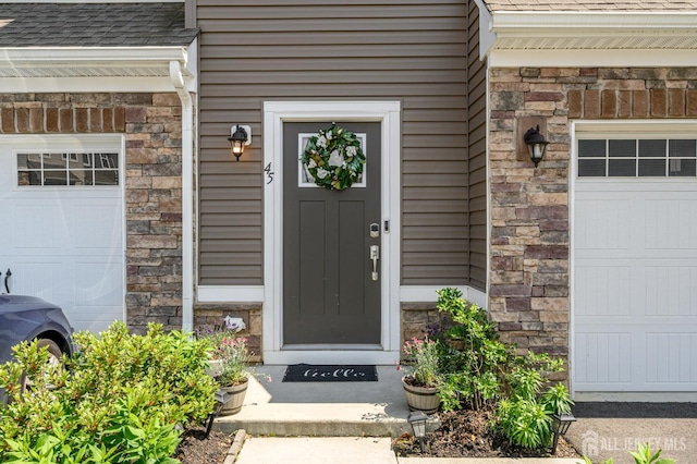 45 Athens Way, Aberdeen, NJ 07721 - entrance to property with a garage, a shingled roof, and stone siding