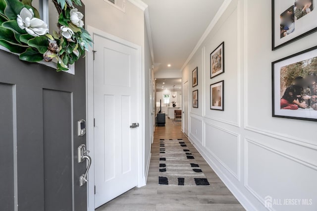 45 Athens Way, Aberdeen, NJ 07721 - entrance foyer with light wood finished floors, crown molding, a decorative wall, and recessed lighting