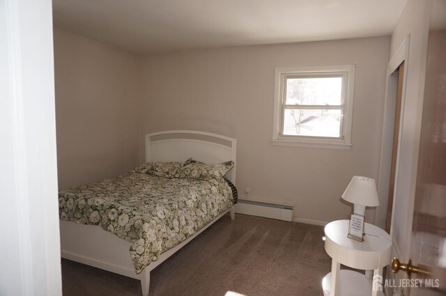 bedroom featuring a baseboard heating unit, carpet flooring, and baseboards