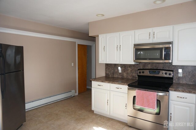 kitchen with stainless steel appliances, a baseboard radiator, dark countertops, decorative backsplash, and white cabinets