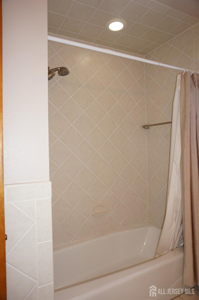 bathroom featuring shower / bathtub combination with curtain