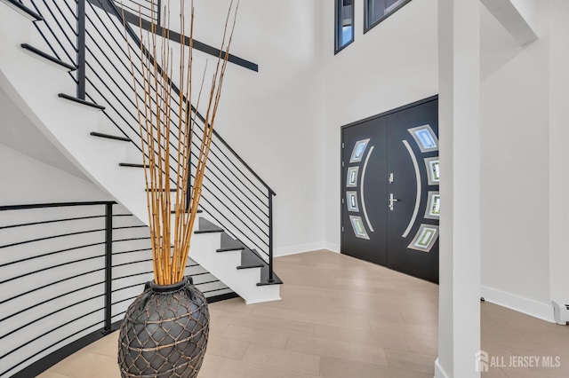 36 School Rd E, Marlboro, NJ 07746 - entryway with wood finished floors, stairs, and a high ceiling